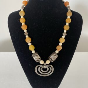 3 Ring Sterling Pendant by Naga By Nevara — three-ring sterling pendant with origami silver and apricot quartz, 50cm.