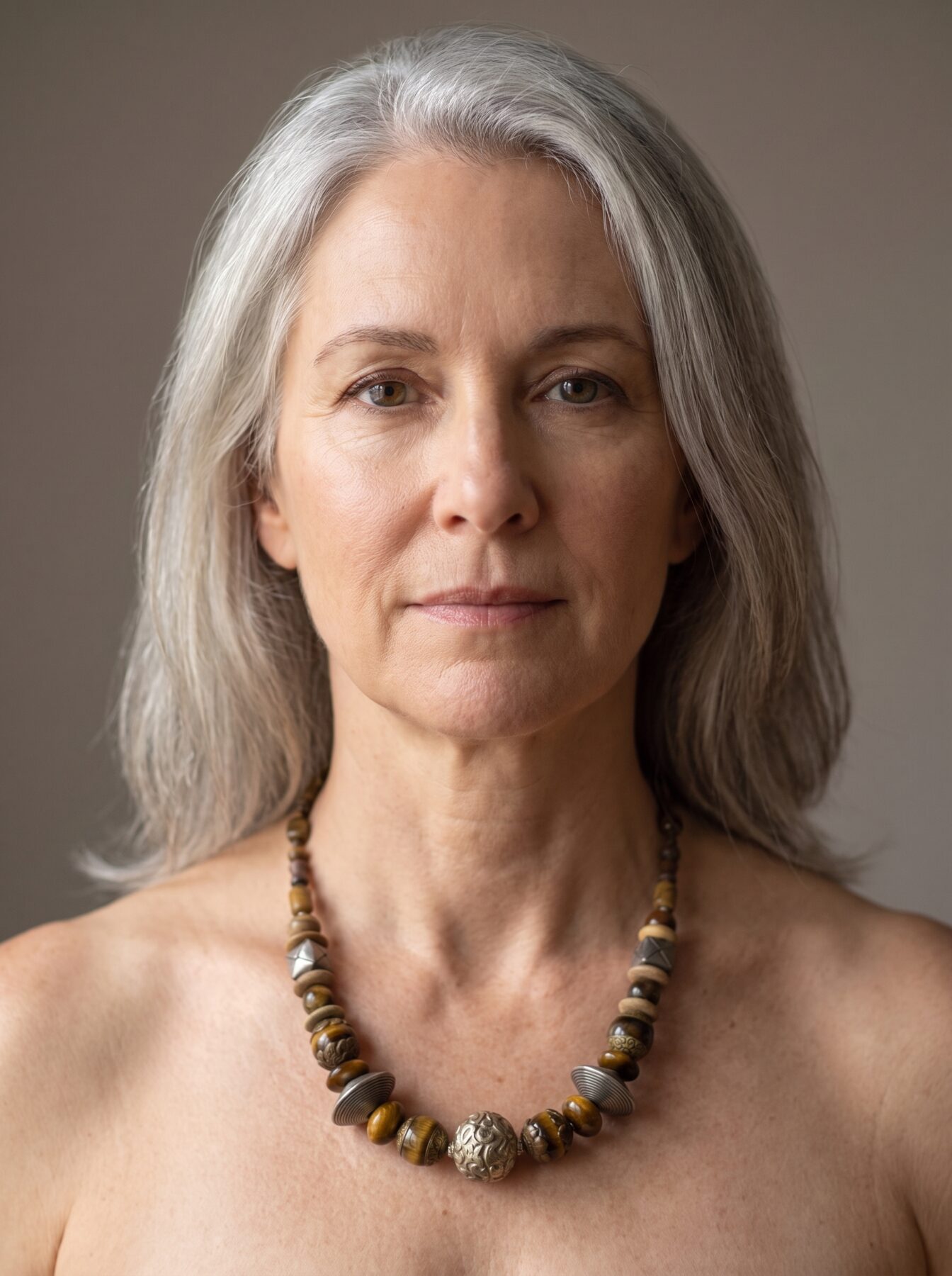 African Tiger Eye necklace by Naga By Nevara worn by a model, front view — tiger eye, antique silver and brass beads