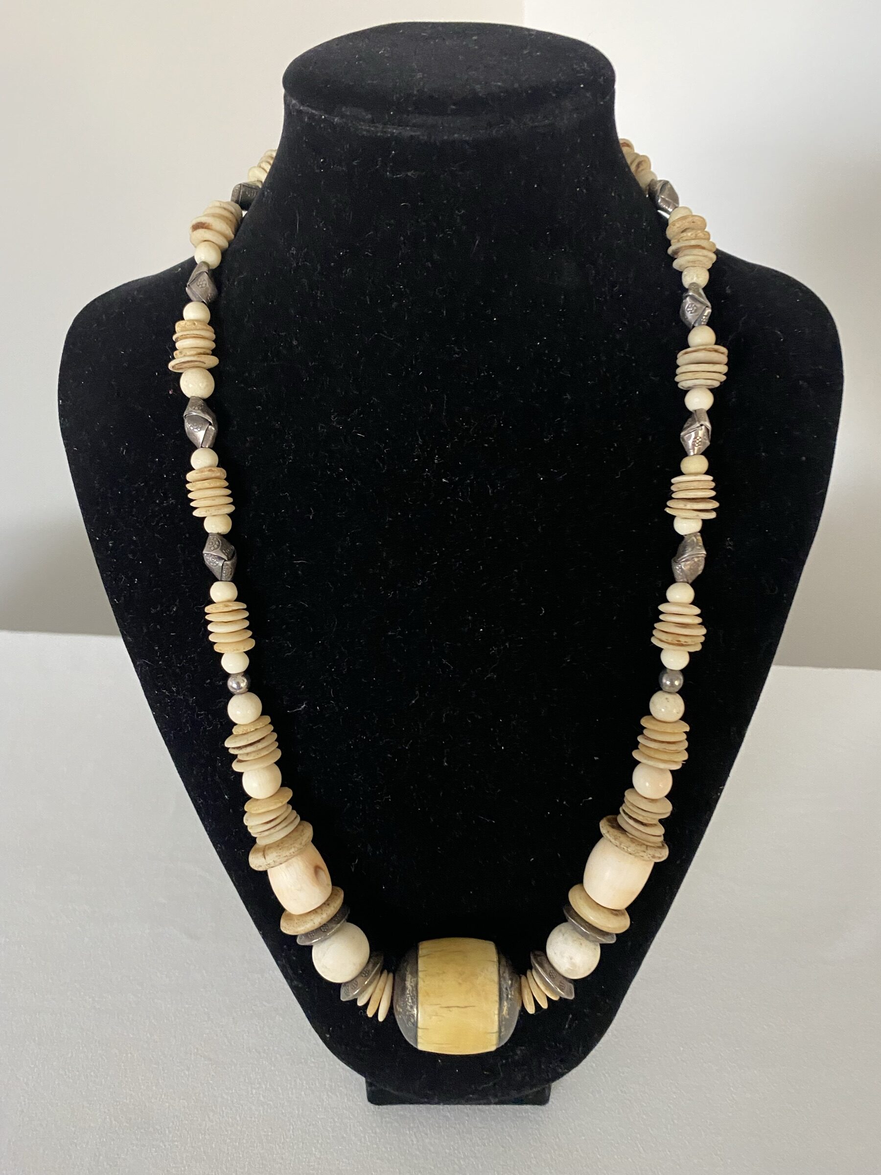 Antique Ivory necklace by Naga By Nevara — antique ivory bead cupped in sterling silver with white coral, origami silver and ostrich egg discs, 60cm.
