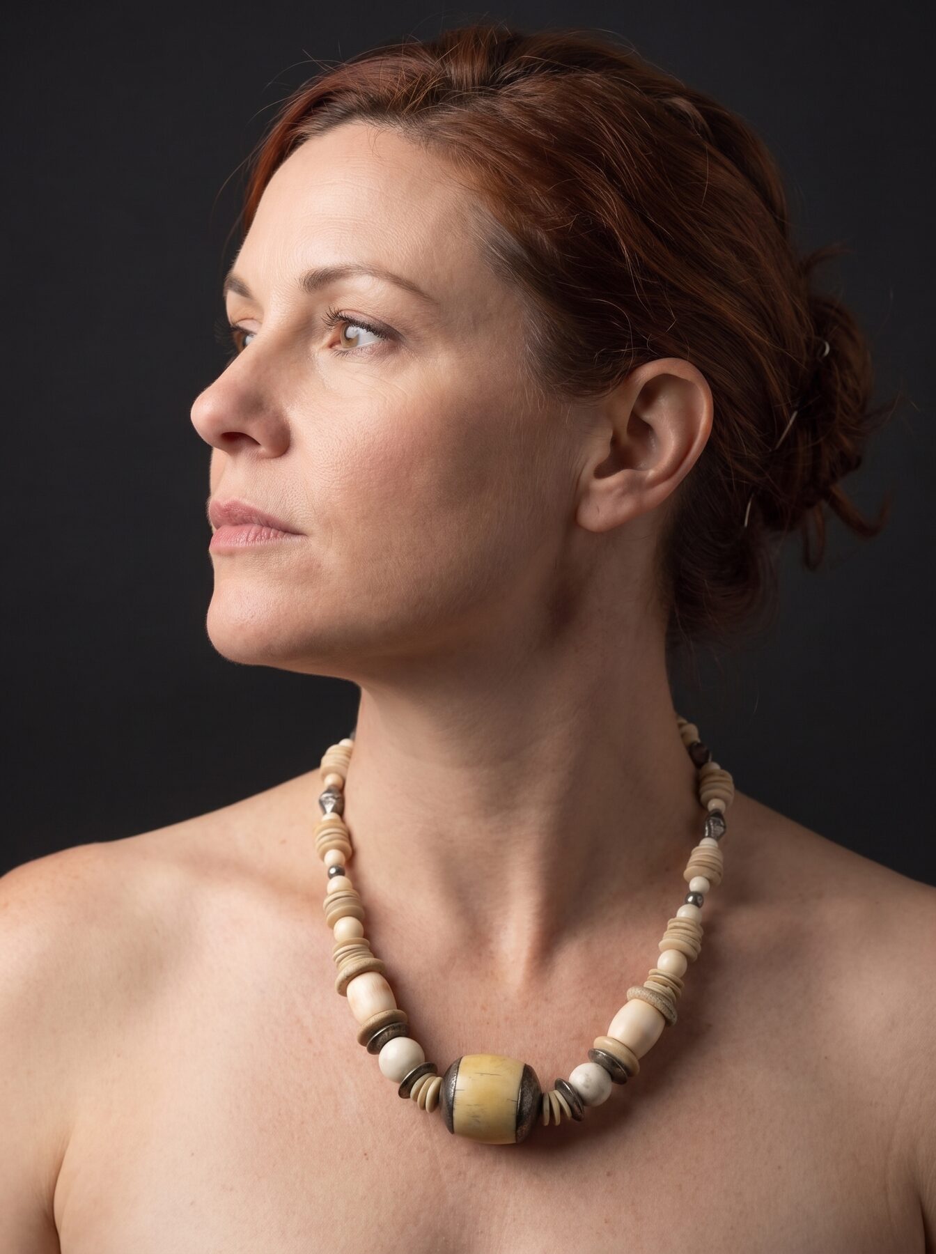 Antique Ivory necklace by Naga By Nevara worn by a model, profile view