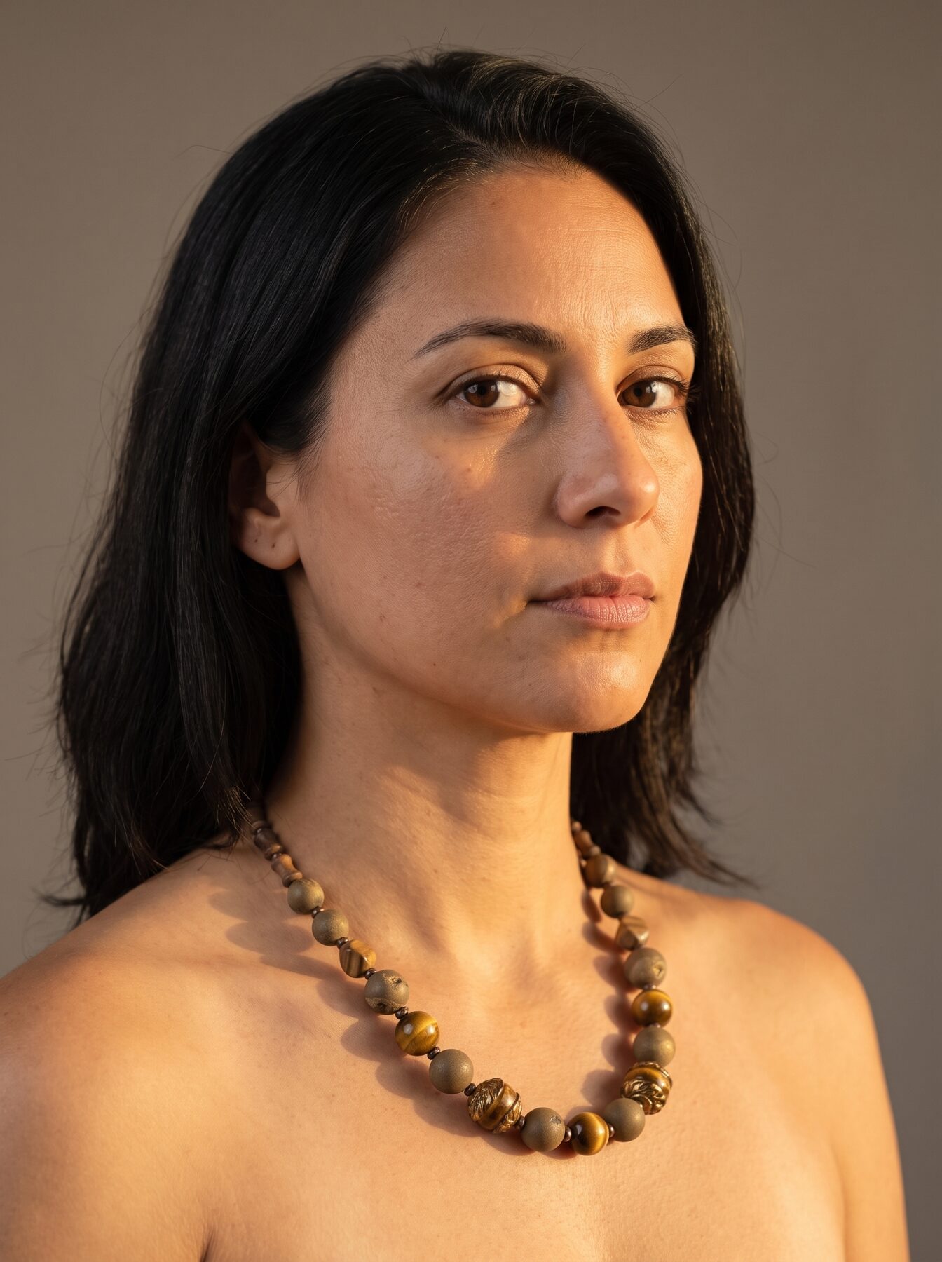 Antique Tiger Eye necklace by Naga By Nevara worn by a model, three quarter view