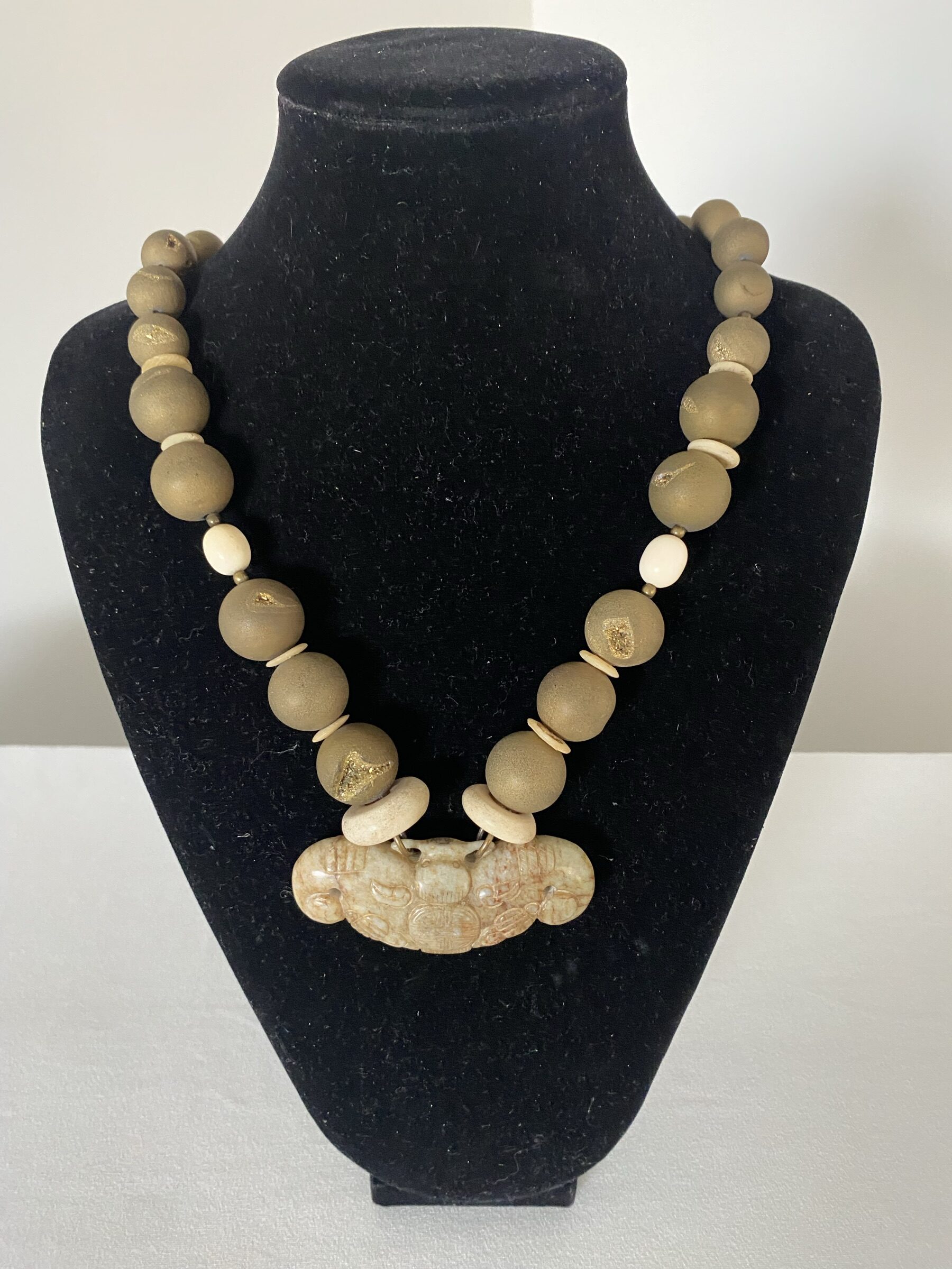 Jade Bat Pendant by Naga By Nevara — jade bat pendant on bone discs with amethyst quartz and ostrich shell discs, 55cm.
