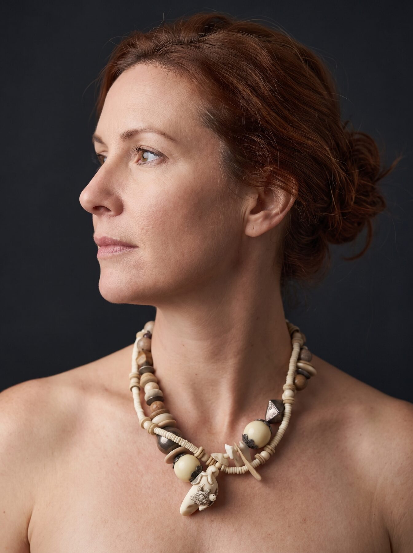 Netsuke with Turtle necklace by Naga By Nevara worn by a model, profile view