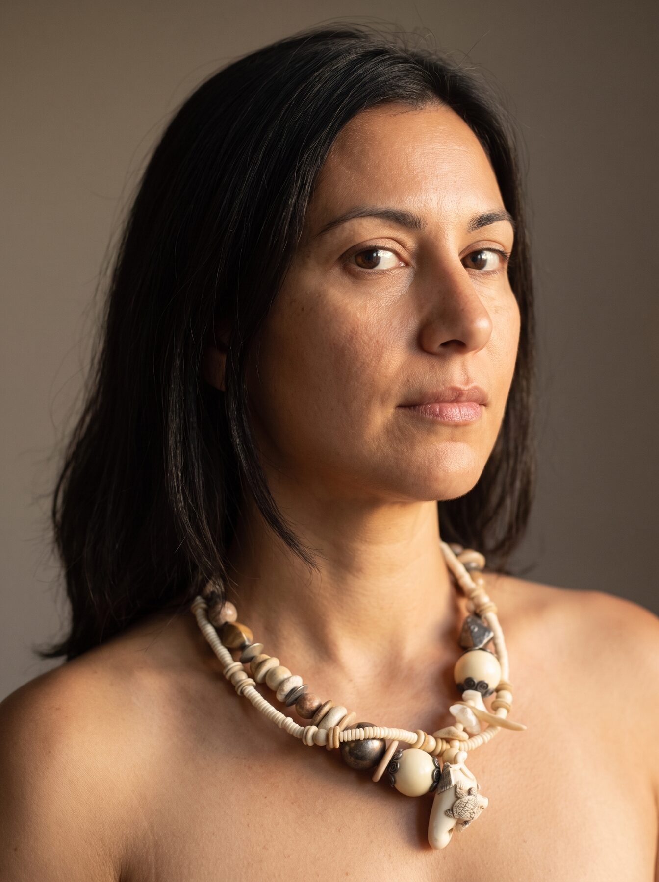 Netsuke with Turtle necklace by Naga By Nevara worn by a model, three quarter view