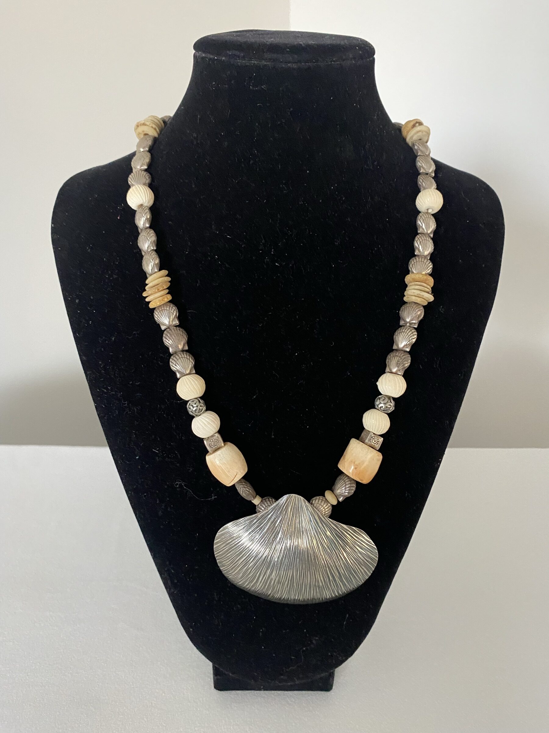 Silver Shell Pendant by Naga By Nevara — large silver shell pendant with white coral, ostrich egg discs and small sterling silver shells, 54cm.