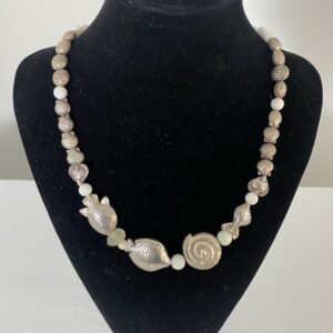 Sterling Silver Fish necklace by Naga By Nevara — sterling silver school of fish with nautilus shell and milky quartz, 55cm.