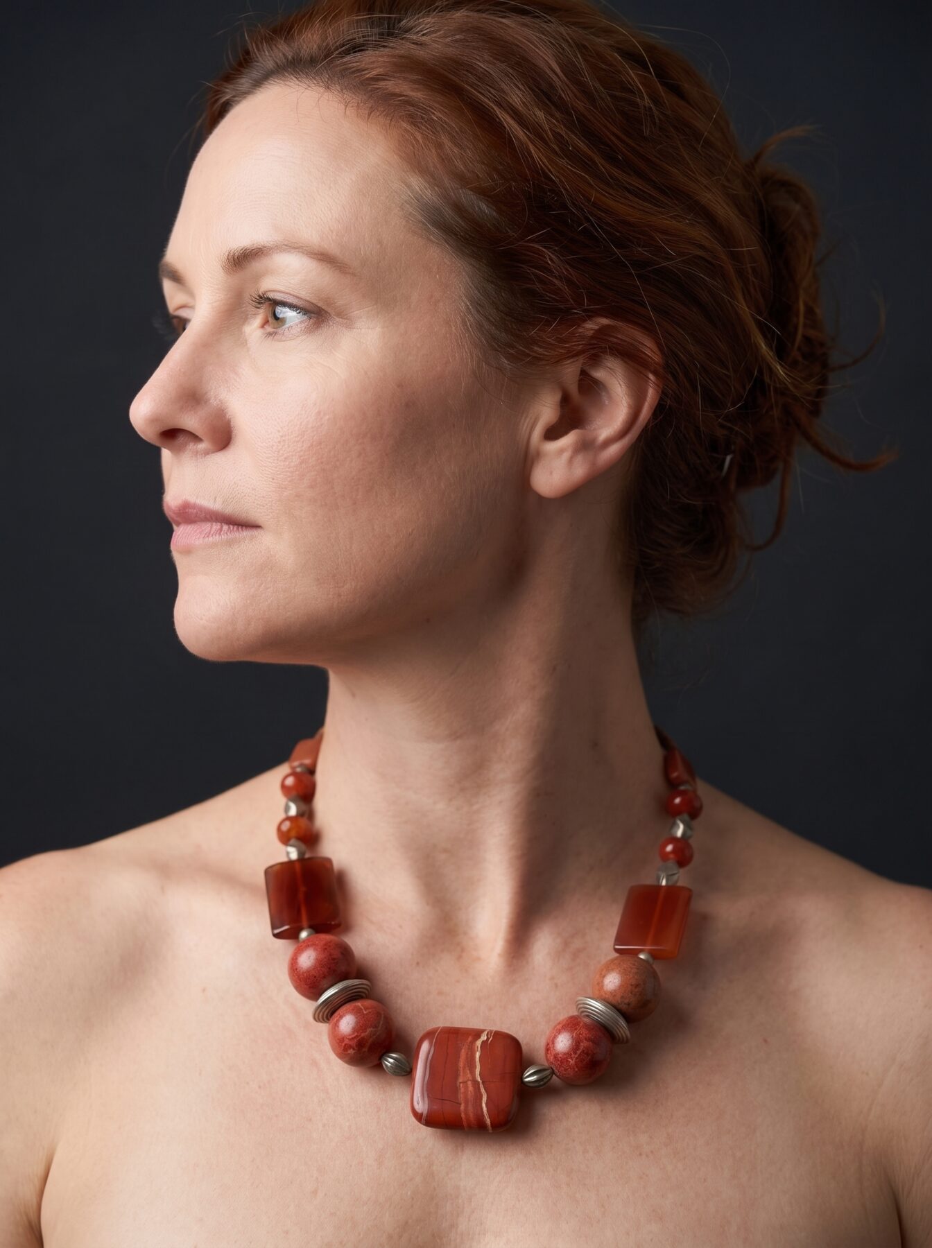 Tangerine Jasper necklace by Naga By Nevara worn by a model, profile view
