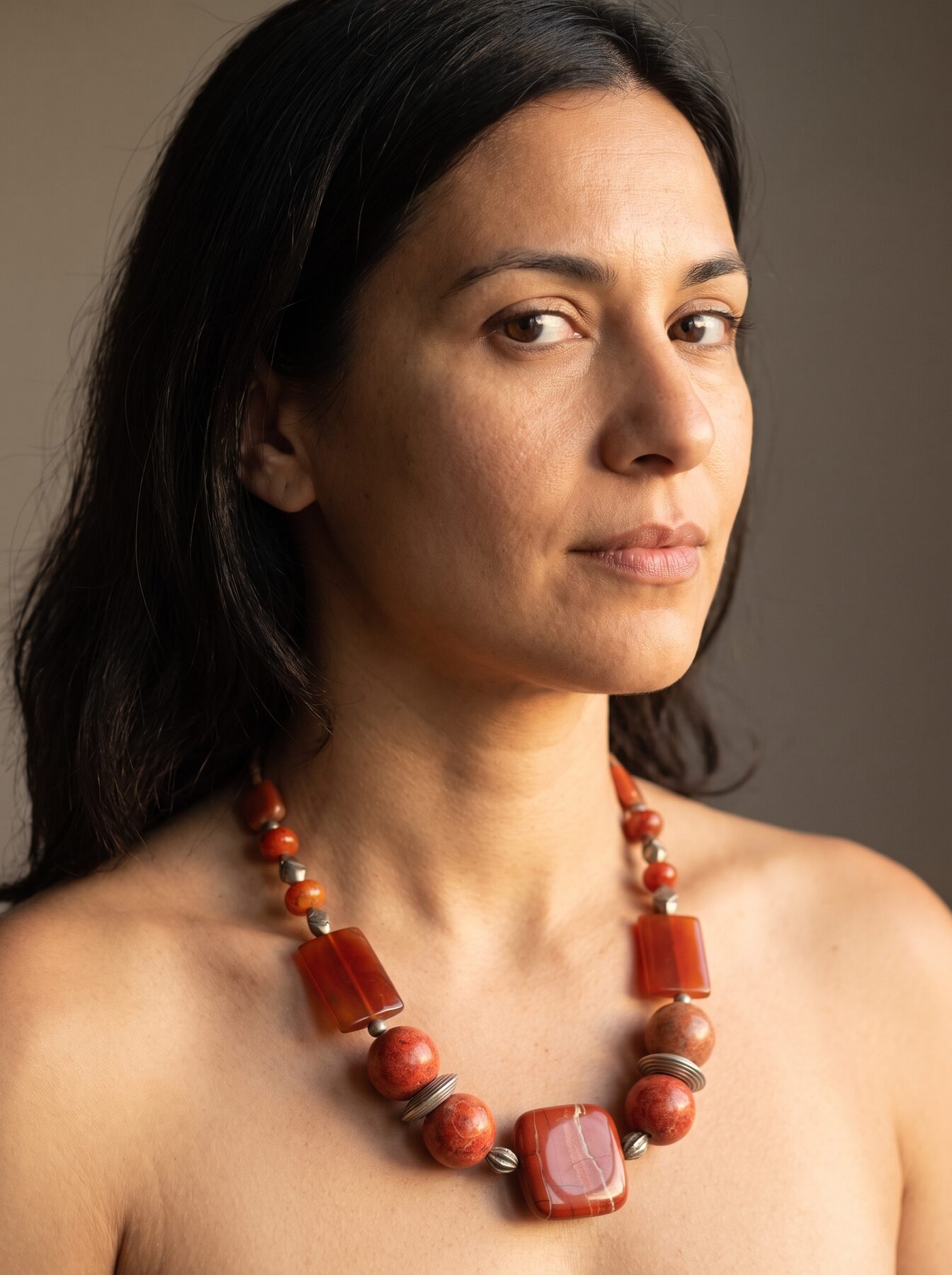 Tangerine Jasper necklace by Naga By Nevara worn by a model, three quarter view